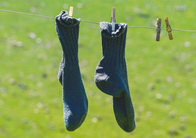 a pair of compression socks drying on a clothesline
