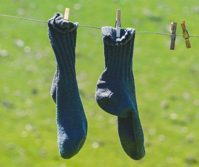 a pair of compression socks drying on a clothesline